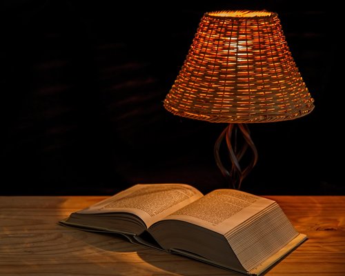 Night reading setup with a warm bedside lamp